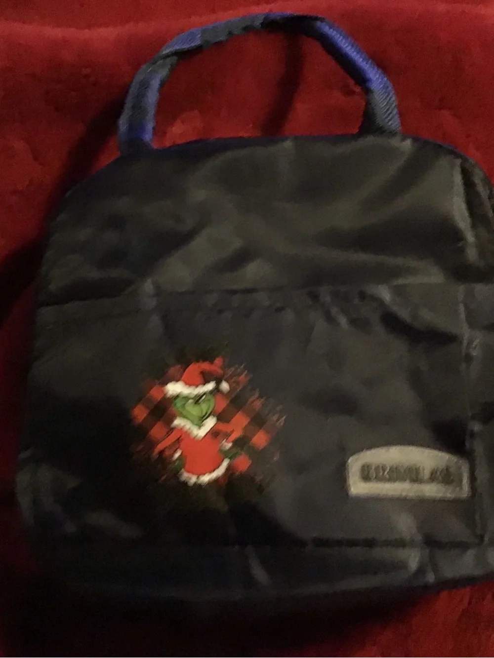 Black insulated lunch bag with Grinch Holiday Graphic